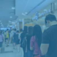 Crowd of people waiting inline at a mall.